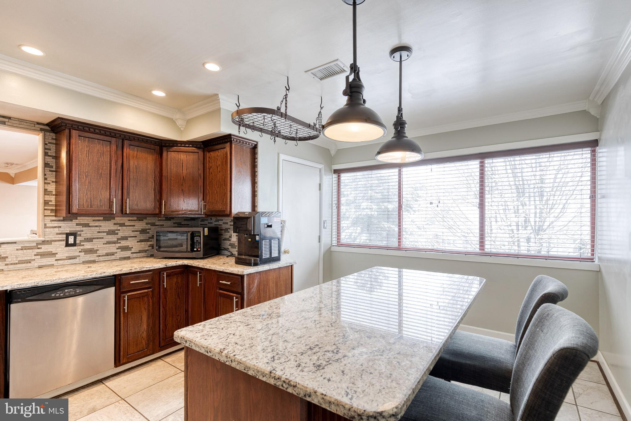 8008 Valley Manor Road, Unit 3B Owings Mills, MD 21117 - Photo 7 of 19 a kitchen with stainless steel appliances granite countertop sink stove and refrigerator
