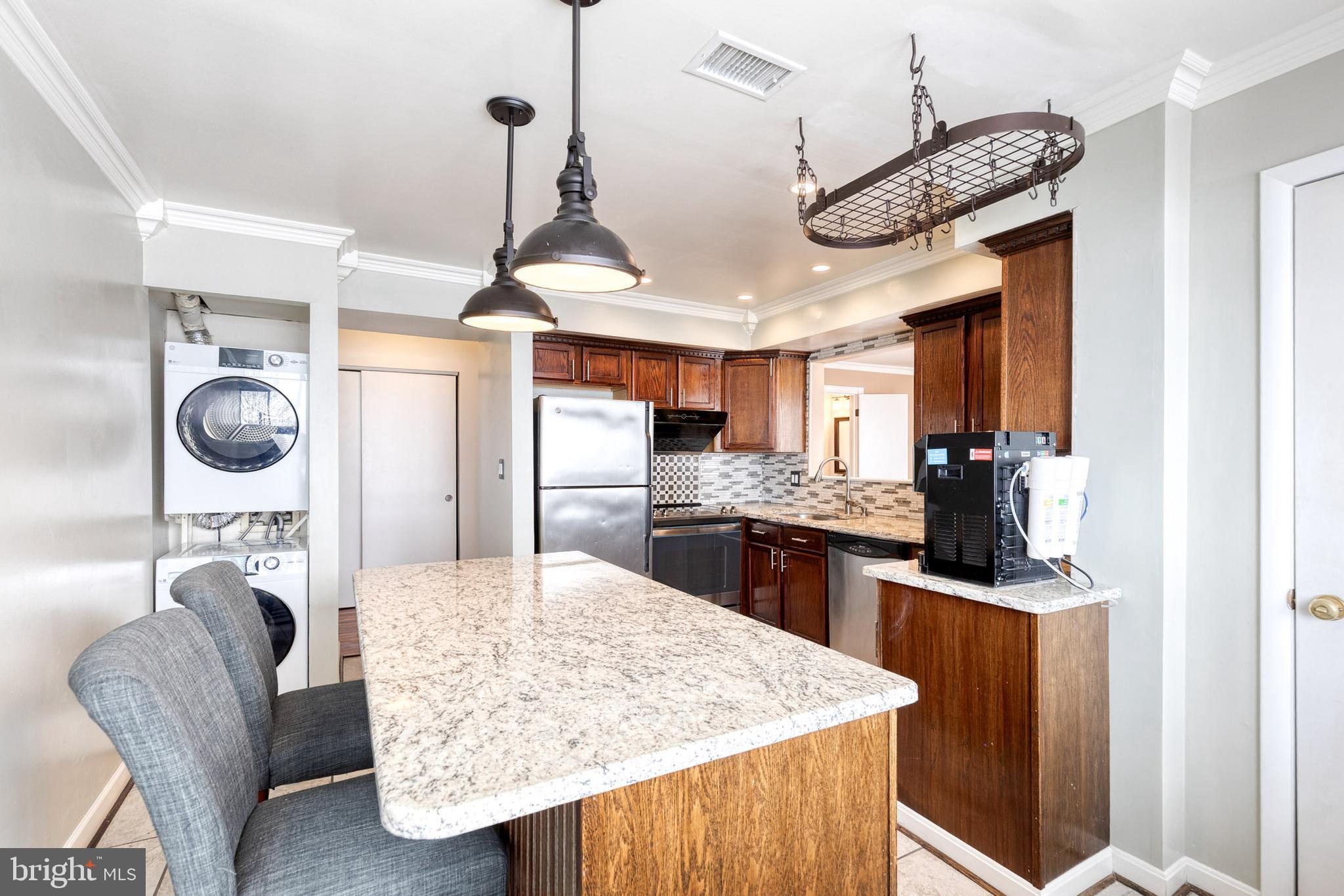 8008 Valley Manor Road, Unit 3B Owings Mills, MD 21117 - Photo 8 of 19 a kitchen with stainless steel appliances granite countertop a sink a stove and refrigerator
