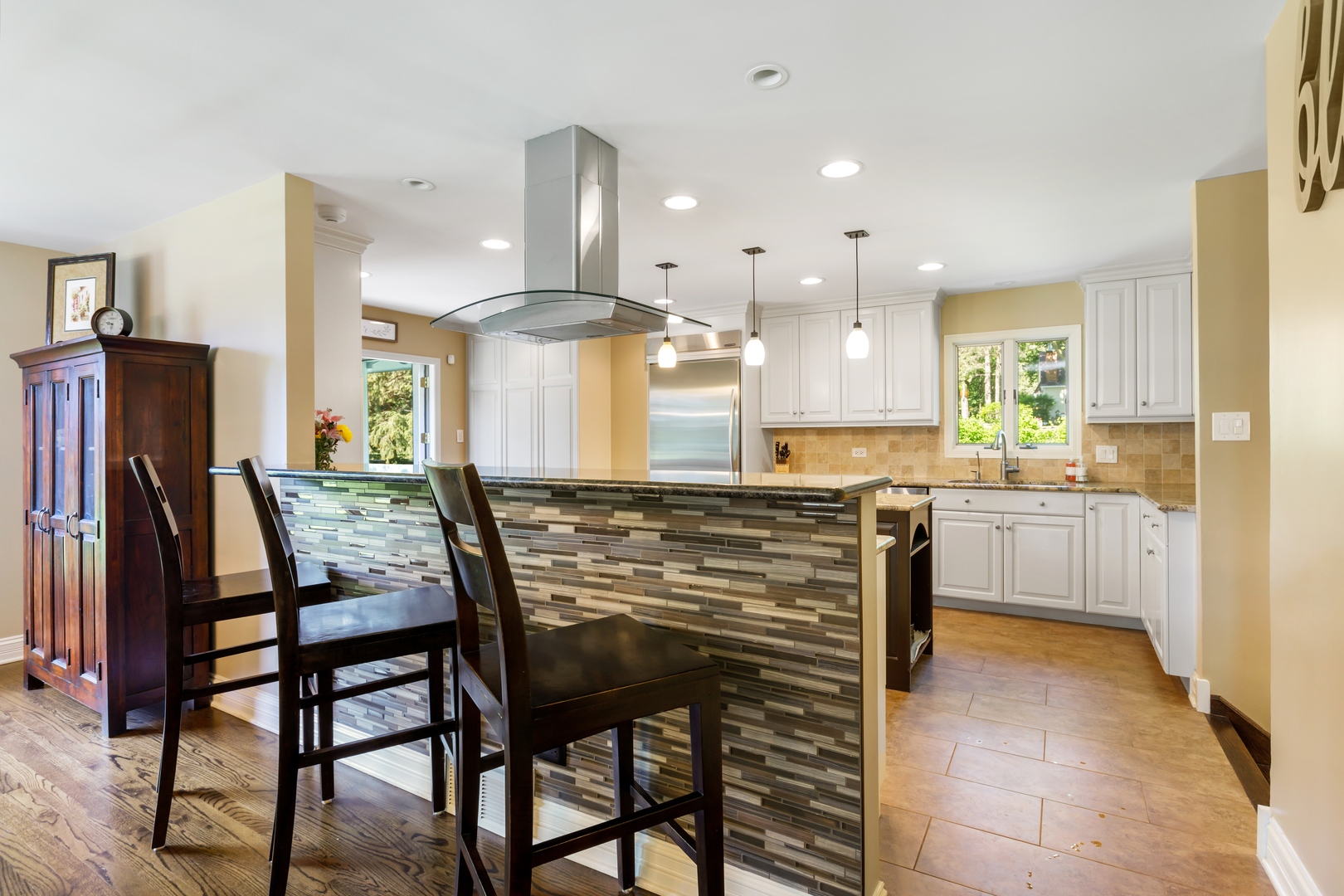 800 Sterling Road Inverness, IL 60067 - Photo 16 of 43 a kitchen with kitchen island granite countertop wooden cabinets and refrigerator
