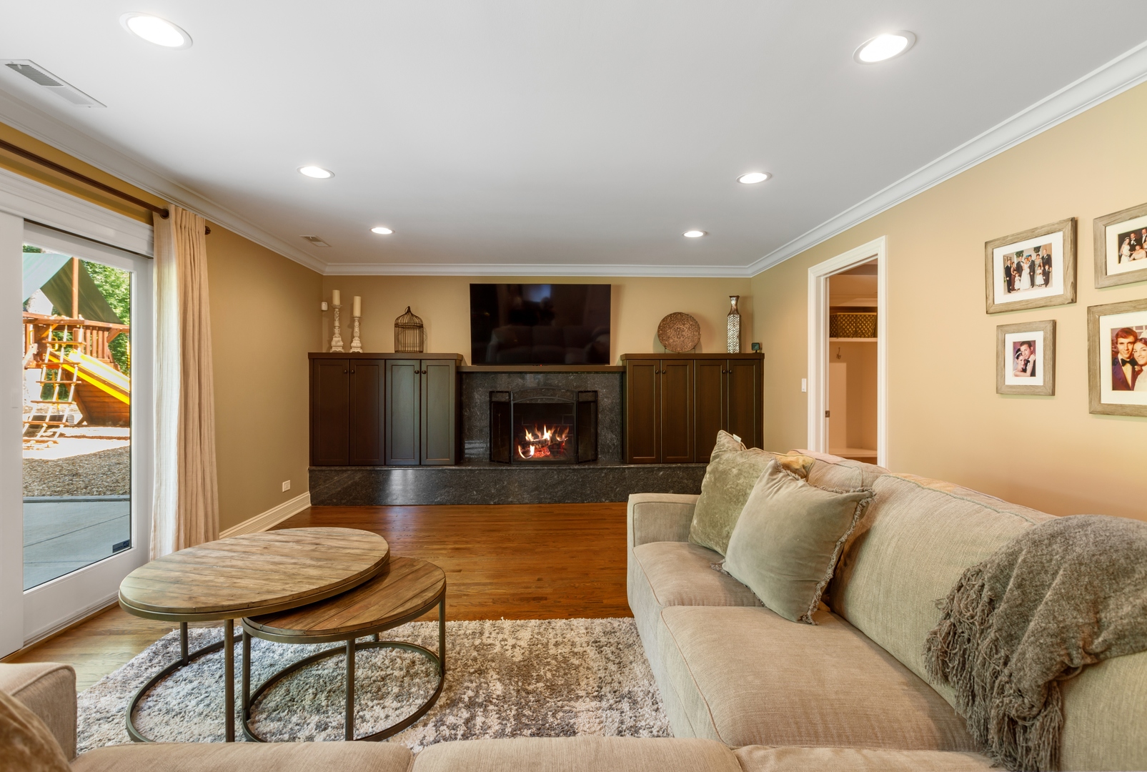 800 Sterling Road Inverness, IL 60067 - Photo 19 of 43 a living room with furniture a fireplace and a flat screen tv