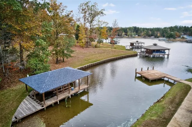 a view of backyard with swimming pool and seating space