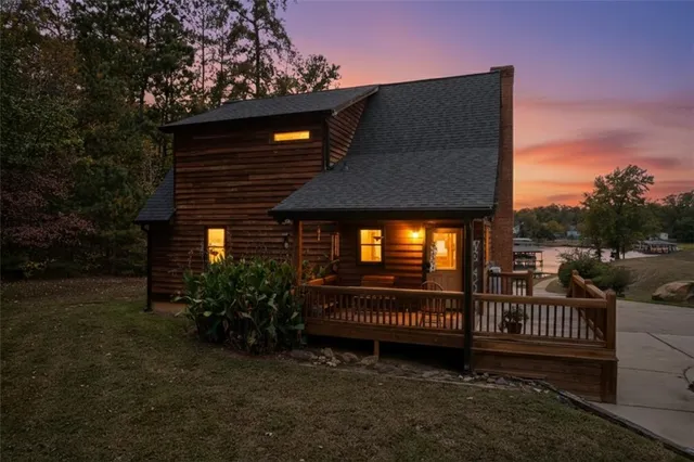 a view of a house with a yard and tree