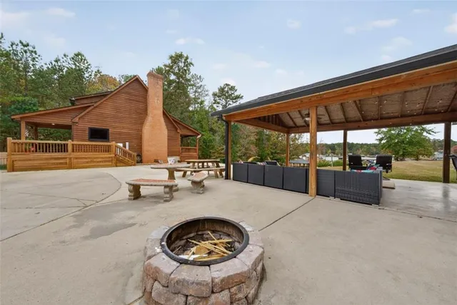 a view of a house with a yard and wooden fence