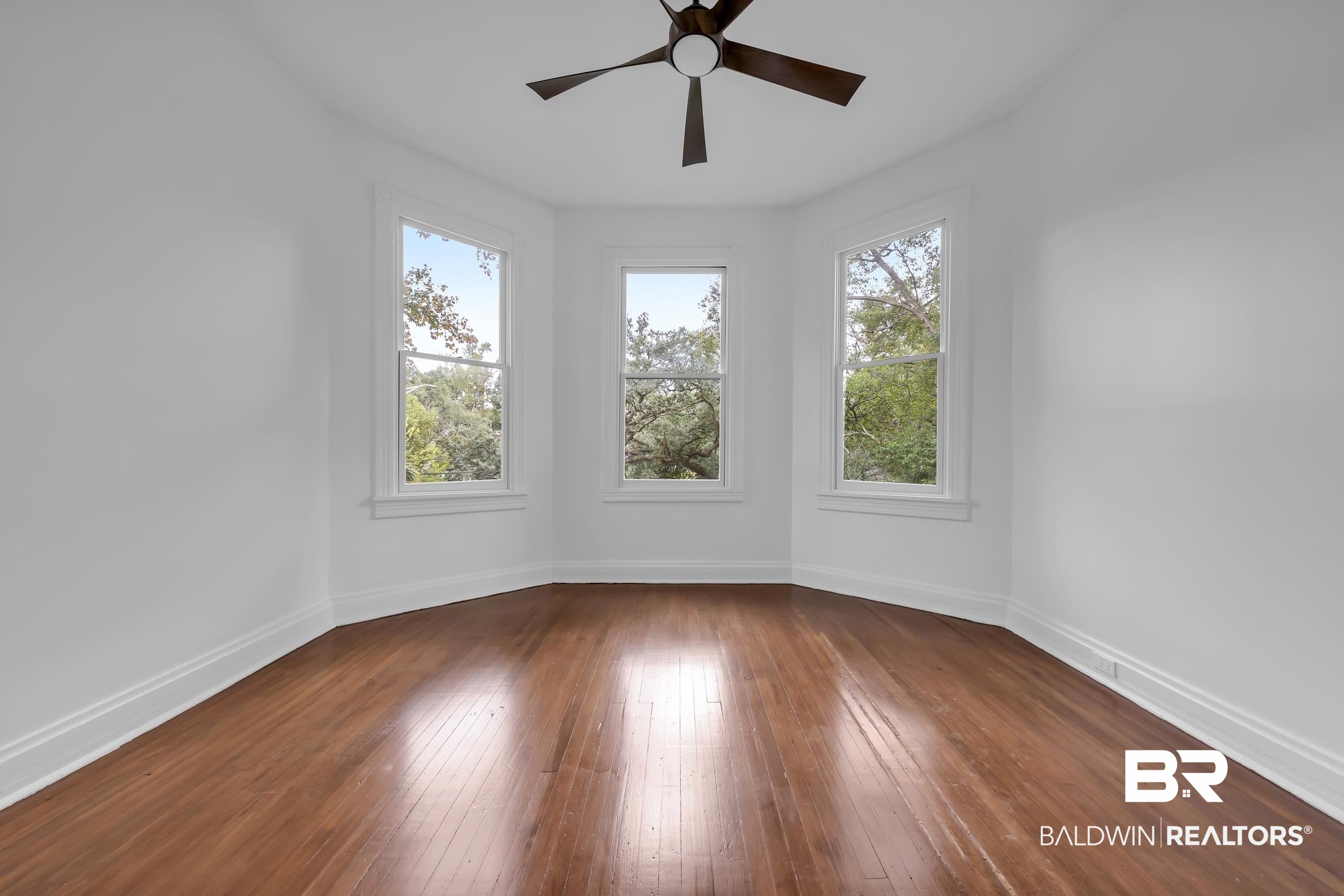 1662 Government Street Mobile, AL 36604 - Photo 28 of 33 Empty room featuring dark wood-type flooring, plenty of natural light, and a ceiling fan