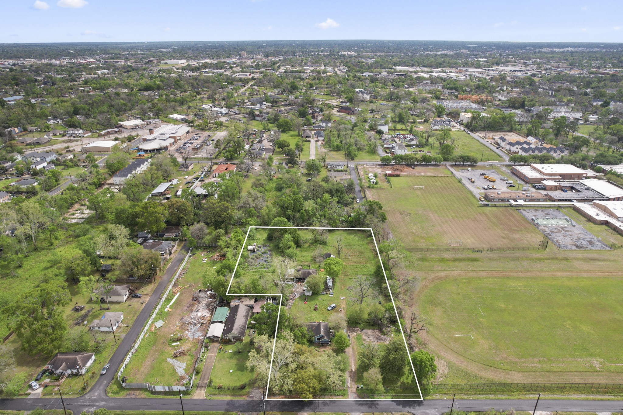 6302 Tuskegee Street Houston, TX 77091 - Photo 2 of 27 an aerial view of residential houses with outdoor space and trees
