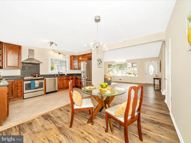 a dining room with furniture and wooden floor