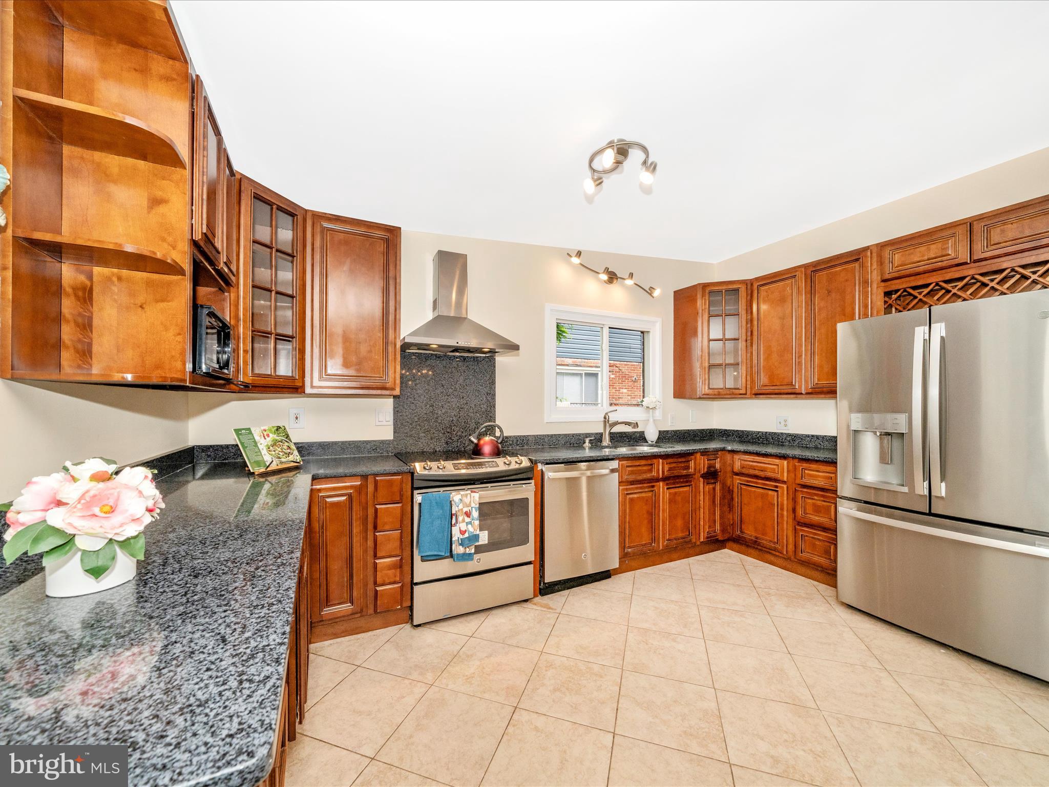 3313 Estelle Terrace Silver Spring, MD 20906 - Photo 13 of 52 a large kitchen with stainless steel appliances granite countertop a stove refrigerator and cabinets