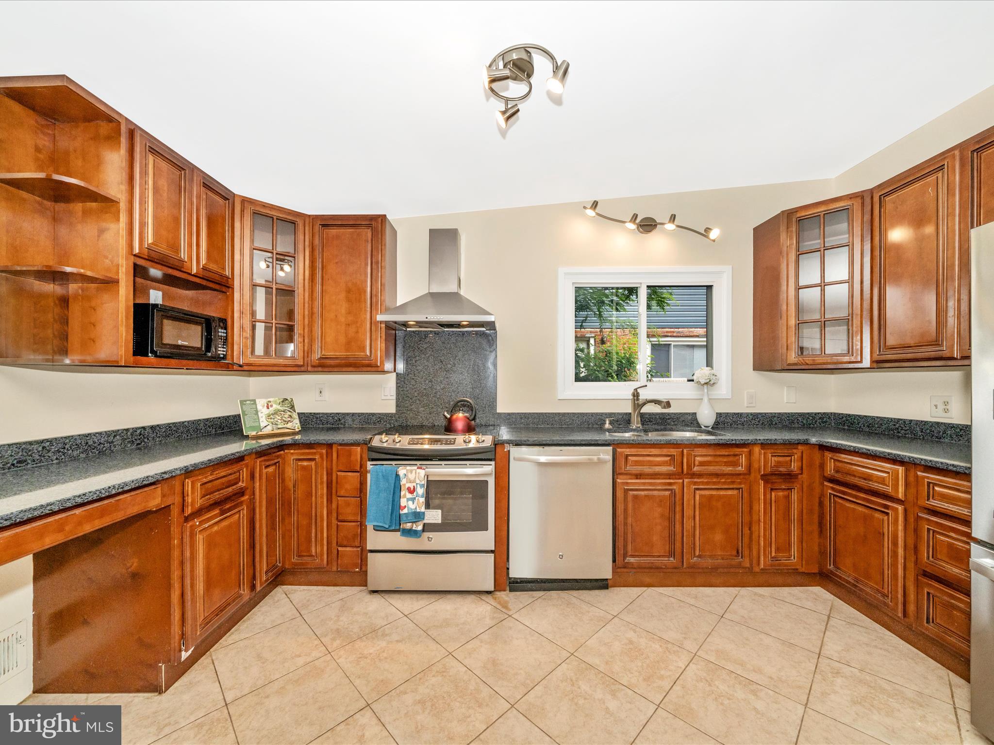 3313 Estelle Terrace Silver Spring, MD 20906 - Photo 15 of 52 a kitchen with stainless steel appliances granite countertop a sink and cabinets