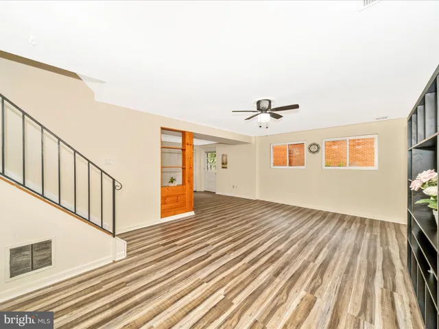 a view of empty room with wooden floor