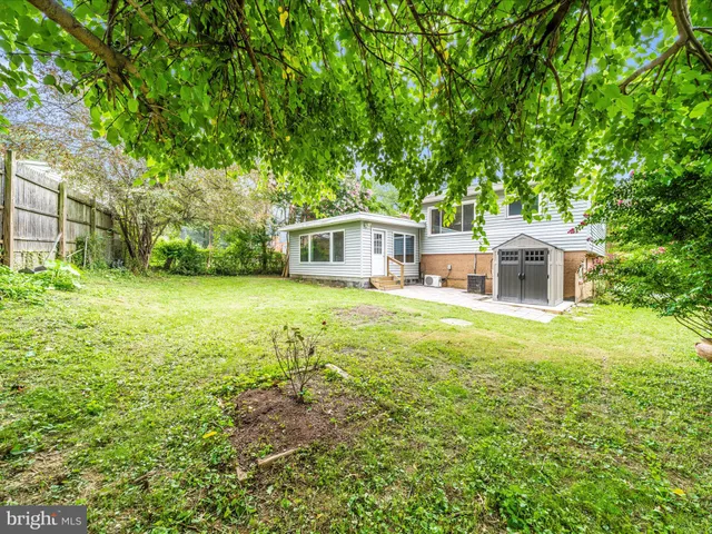 a view of a house with a yard and sitting area