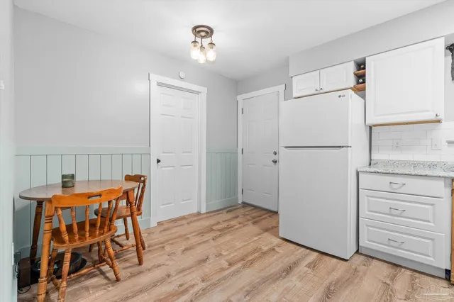 a dining room with furniture and wooden floor