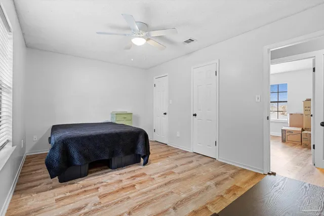 a living room with a bed furniture and a window