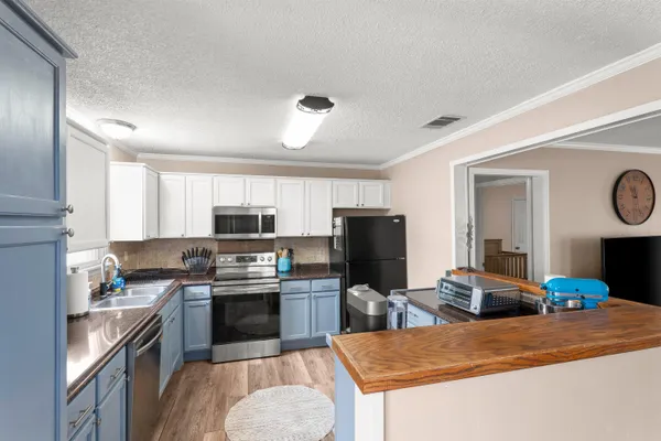 a kitchen with a sink a stove and refrigerator