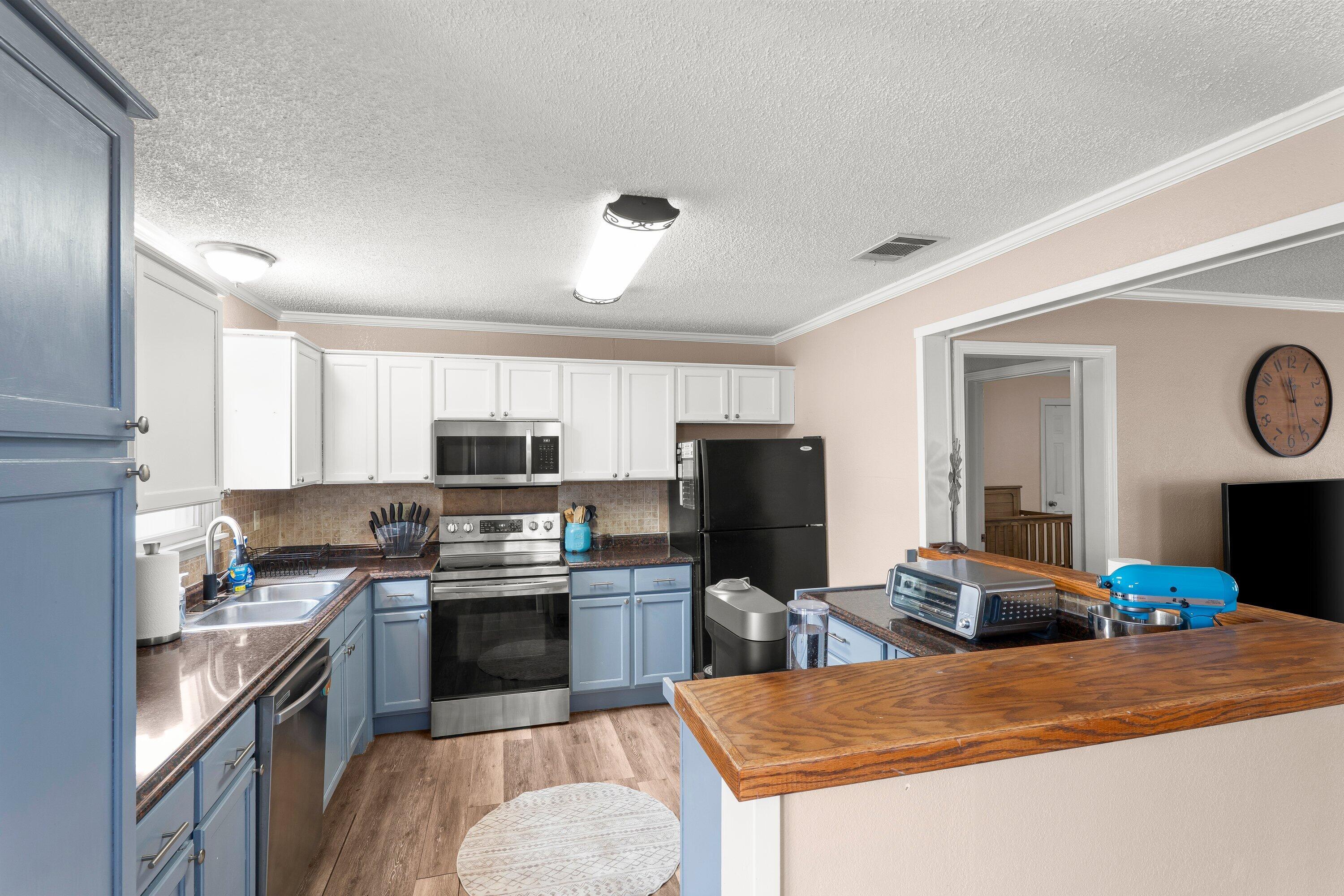 505 East 15th Street Littlefield, TX 79339 - Photo 1 of 22 a kitchen with a sink a stove and refrigerator