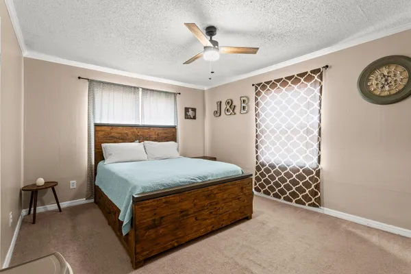 a bedroom with a bed and a table in it