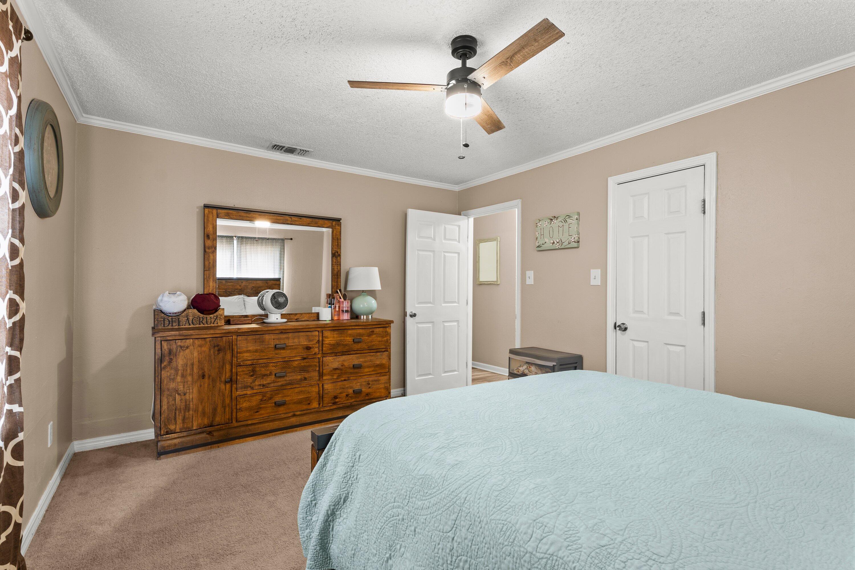 505 East 15th Street Littlefield, TX 79339 - Photo 17 of 22 a bed room with a bed and a dresser