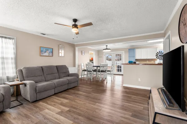 a living room with furniture flat screen tv and a window