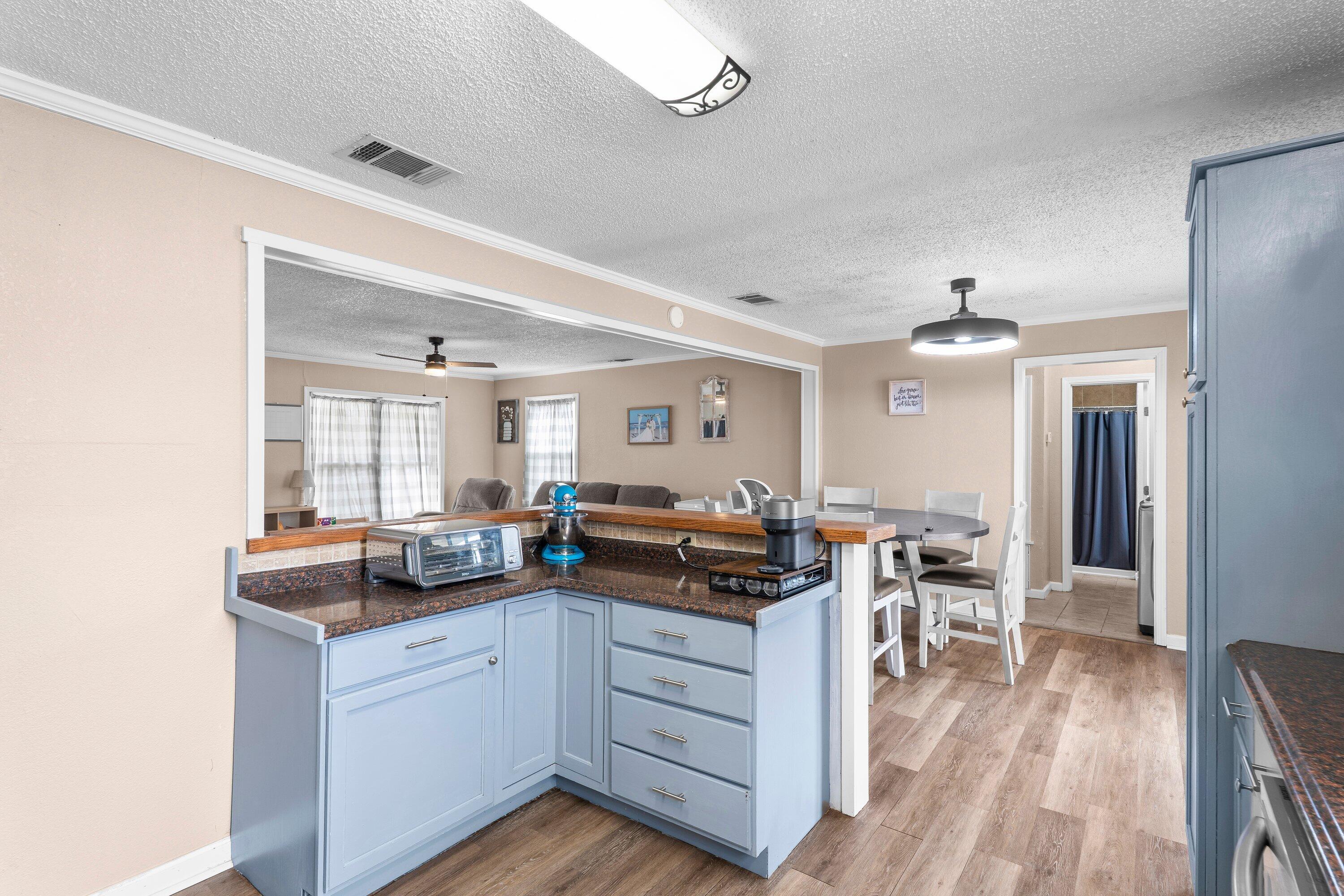 505 East 15th Street Littlefield, TX 79339 - Photo 9 of 22 a kitchen with counter top space and wooden floor