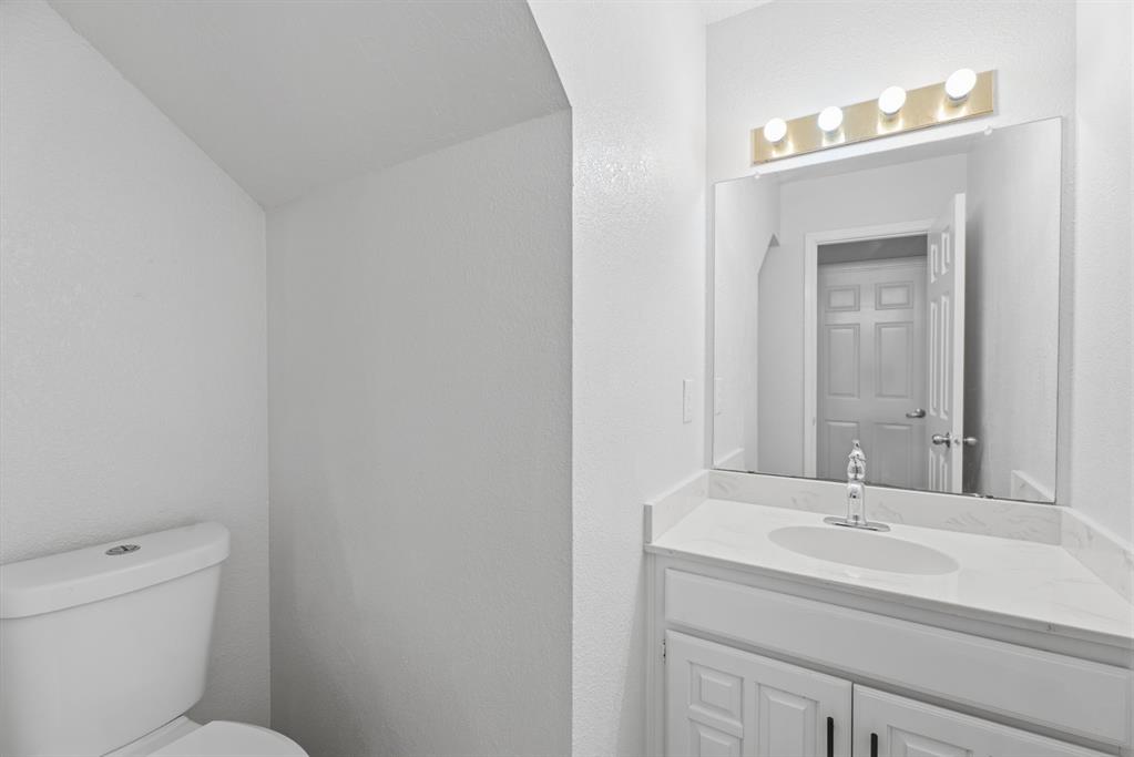 3721 Smartt Street Rowlett, TX 75088 - Photo 10 of 27 a bathroom with a sink and a toilet