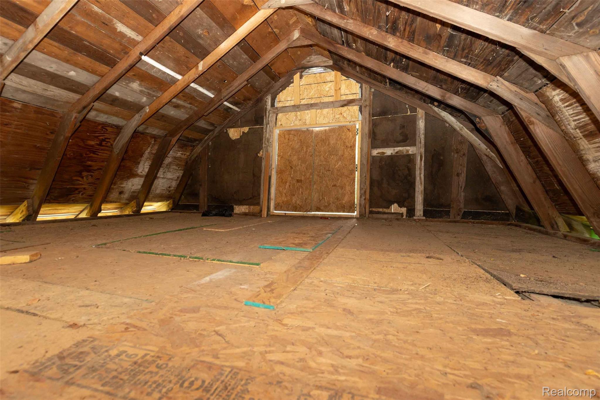 5761 Genesee Road Lapeer, MI 48446 - Photo 43 of 52 Unfinished attic space featuring exposed wood rafters and subflooring