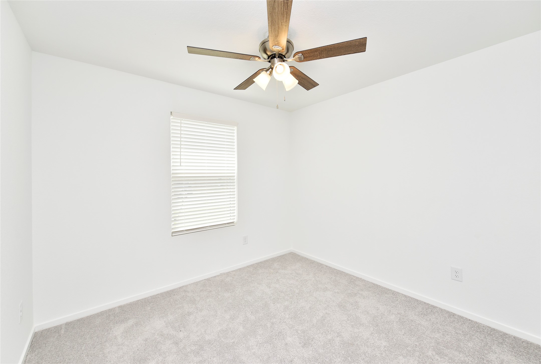10218 Prairie Dunes Lane Cleveland, TX 77327 - Photo 27 of 32 an empty room with a window and a fan