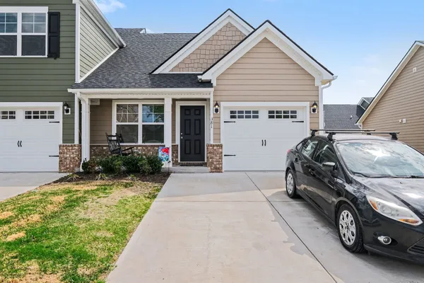 a view of a car parked front of a house
