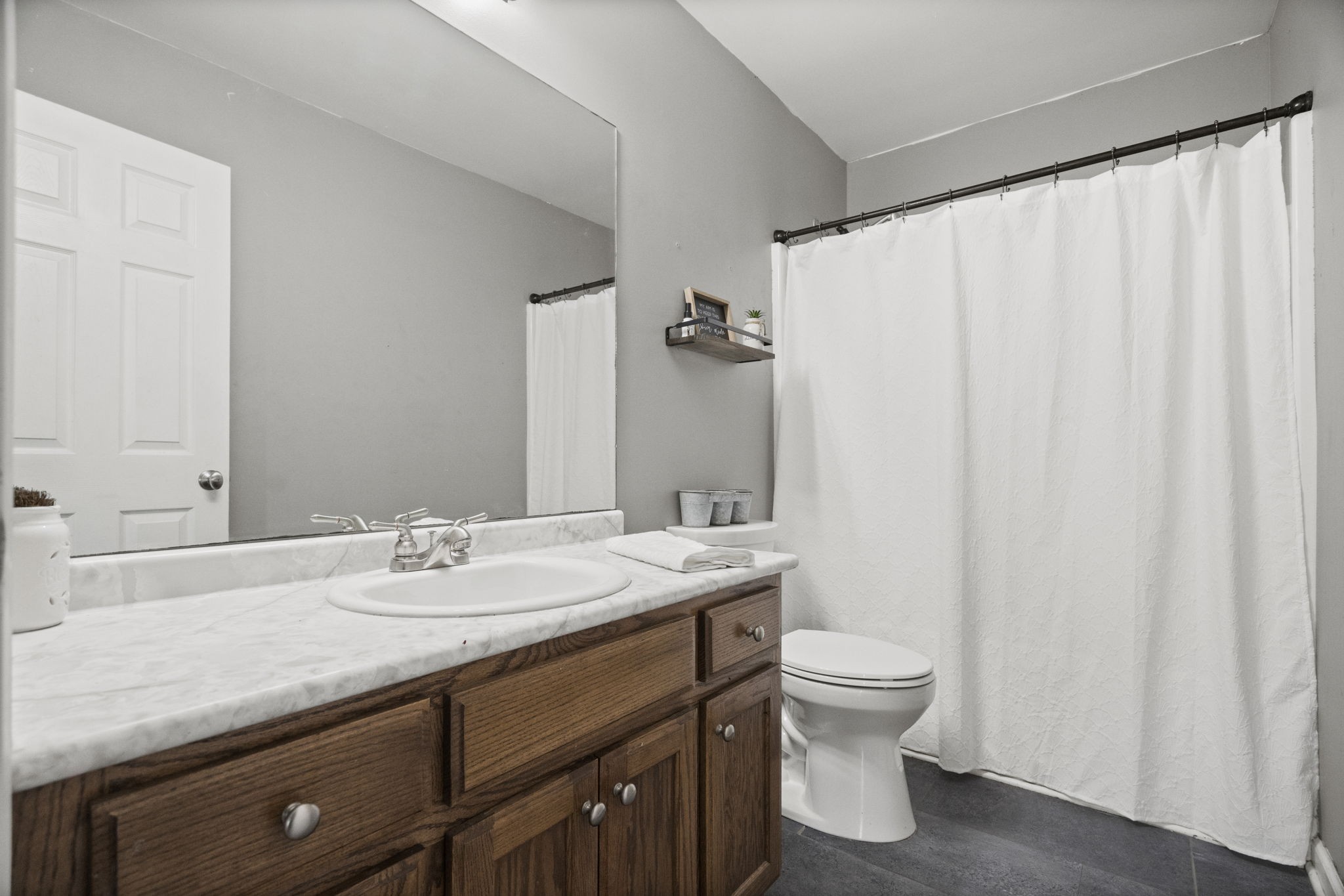 5958 Fred Perry Road Springfield, TN 37172 - Photo 16 of 32 a bathroom with a sink a toilet and shower curtain