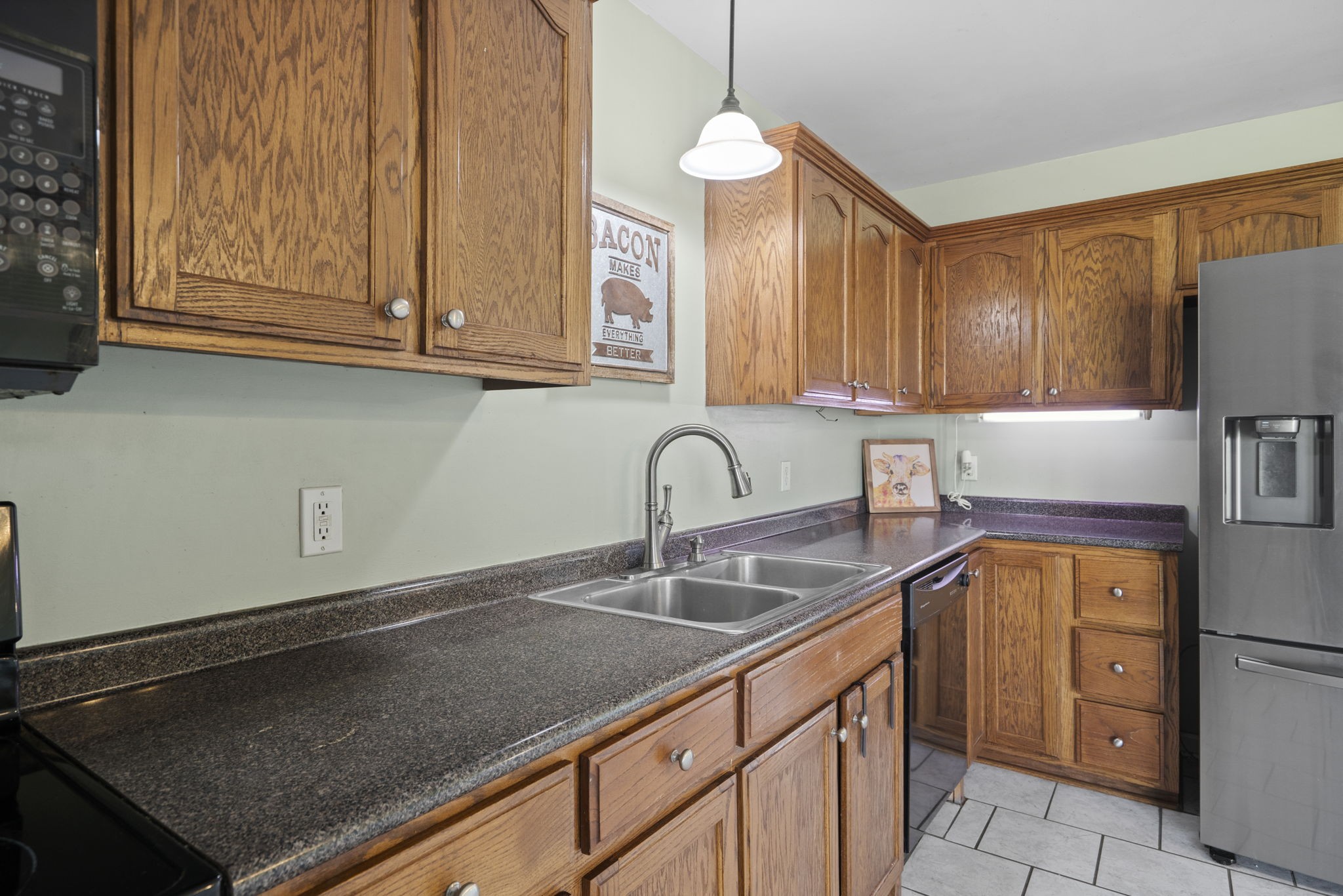 5958 Fred Perry Road Springfield, TN 37172 - Photo 21 of 32 a kitchen with stainless steel appliances granite countertop a sink a stove and a microwave oven in a white refrigerator