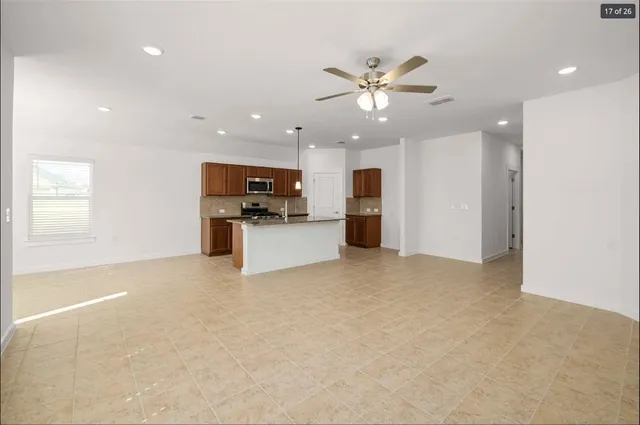 a view of a kitchen with a sink a refrigerator and microwave