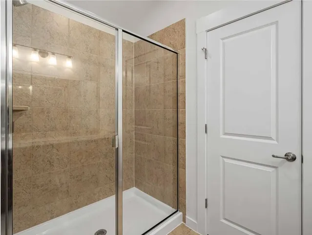 a bathroom with a glass shower door