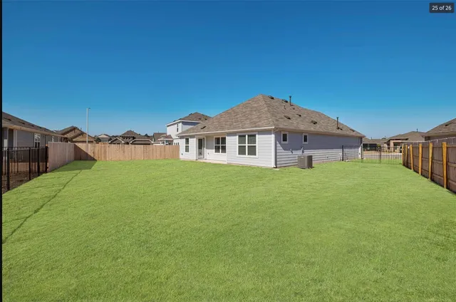 a view of a house with backyard and porch