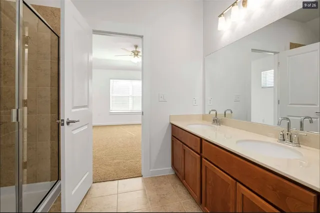 a bathroom with a sink a mirror and a shower