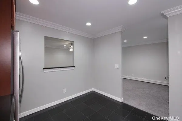 an empty room with wooden floor and mirror