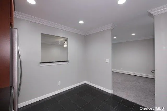 an empty room with wooden floor and mirror