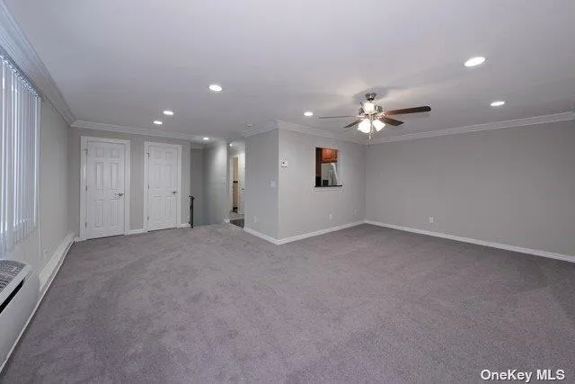a view of an empty room with a ceiling fan