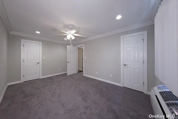 an empty room with closet and a ceiling fan