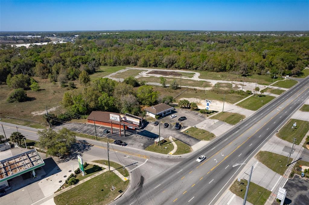 4030 Northwest Blitchton Road Ocala, FL 34482 - Photo 18 of 20 a view of a balcony with dining table and chairs with wooden floor