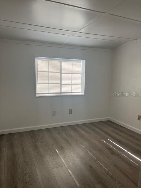 10315 Cortez Road West, Unit 1B Bradenton, FL 34210 - Photo 17 of 49 an empty room with wooden floor and windows