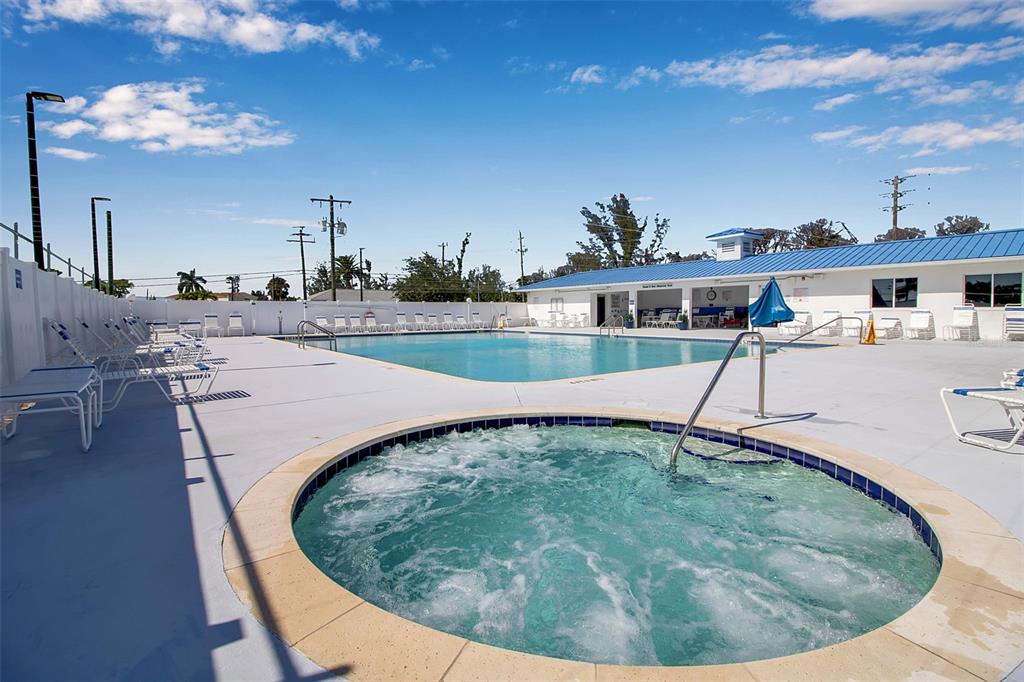 10315 Cortez Road West, Unit 1B Bradenton, FL 34210 - Photo 47 of 49 a view of a swimming pool with a lounge chair