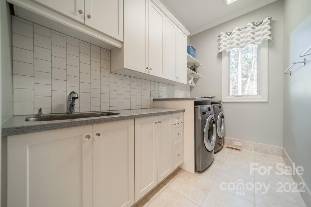 104 Maddaket Loop Mooresville, NC 28117 - Photo 20 of 45 a kitchen with a white cabinets and a window