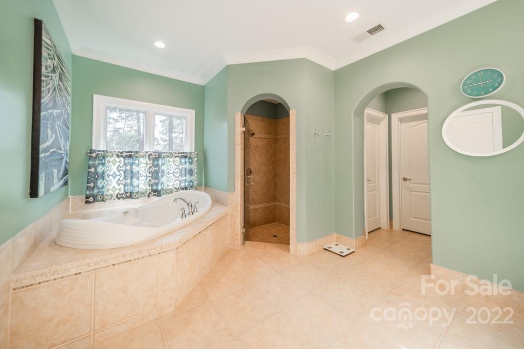 104 Maddaket Loop Mooresville, NC 28117 - Photo 27 of 45 a bathroom with a tub a double vanity sink and mirror