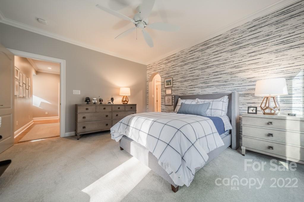 104 Maddaket Loop Mooresville, NC 28117 - Photo 28 of 45 a spacious bedroom with a bed and a cabinets