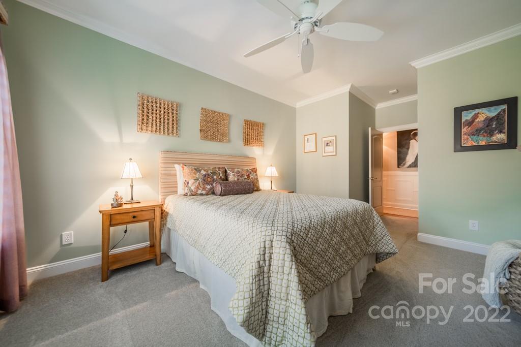 104 Maddaket Loop Mooresville, NC 28117 - Photo 30 of 45 a bedroom with a bed and a chandelier