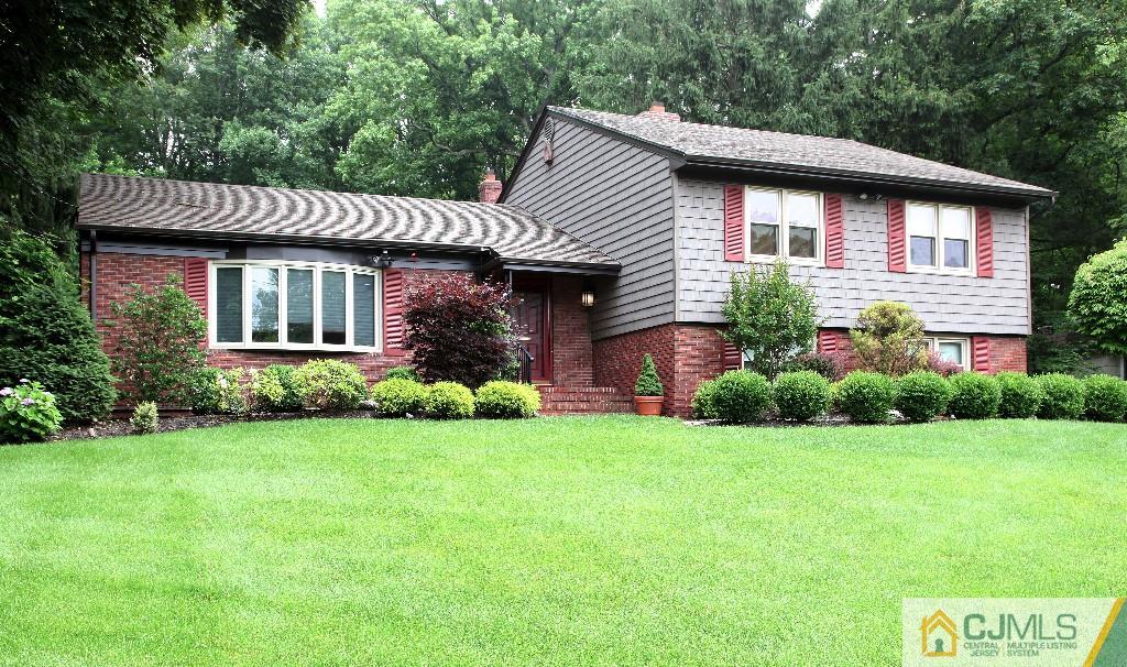 25 Clive Hills Road Edison, NJ 08820 - Photo 1 of 25 a front view of a house with a garden and yard