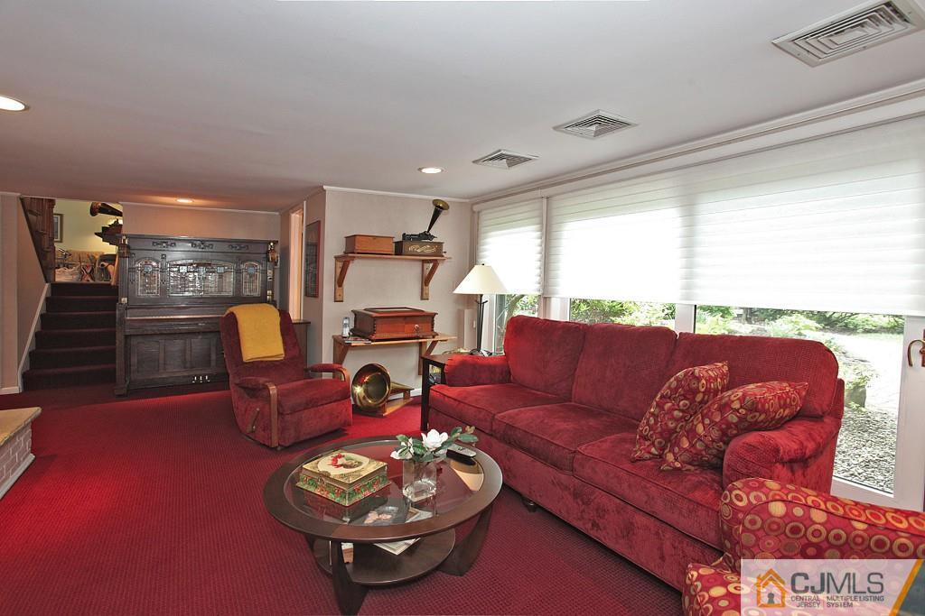 25 Clive Hills Road Edison, NJ 08820 - Photo 13 of 25 a living room with furniture a rug and a large window