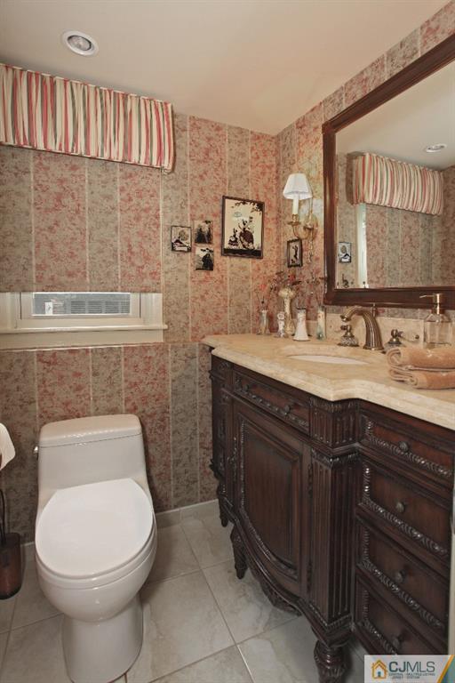 25 Clive Hills Road Edison, NJ 08820 - Photo 14 of 25 a bathroom with a toilet sink and mirror