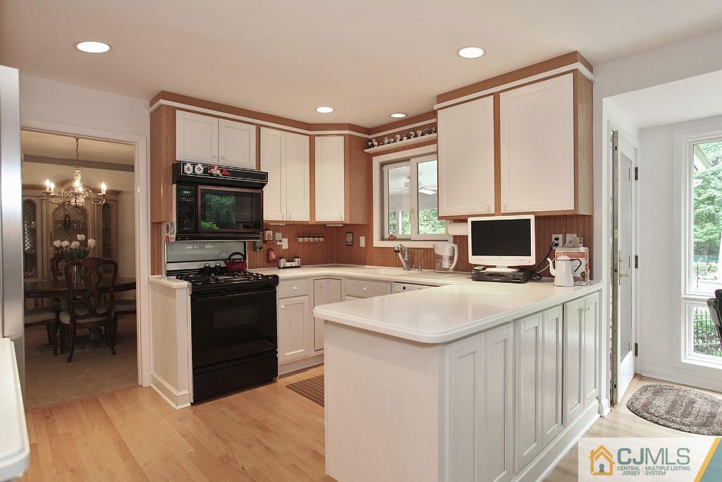 25 Clive Hills Road Edison, NJ 08820 - Photo 17 of 25 a kitchen with a stove a sink and a refrigerator