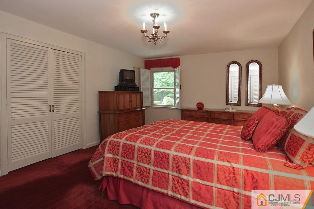 25 Clive Hills Road Edison, NJ 08820 - Photo 21 of 25 a bedroom with a bed and a closet
