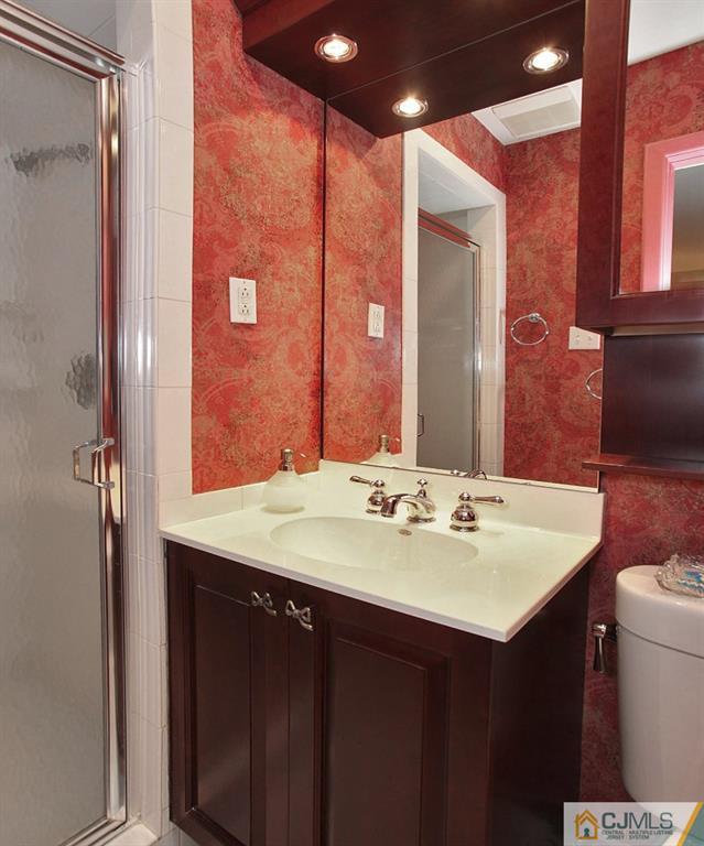25 Clive Hills Road Edison, NJ 08820 - Photo 22 of 25 a bathroom with a sink and a mirror
