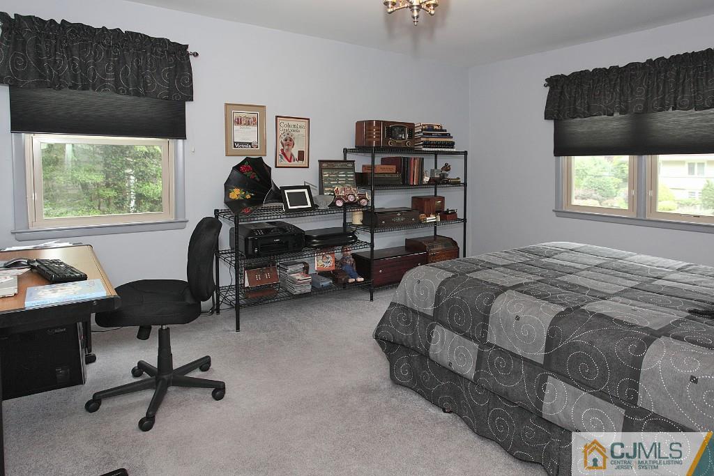 25 Clive Hills Road Edison, NJ 08820 - Photo 23 of 25 a bedroom with a bed gym equipment and a window